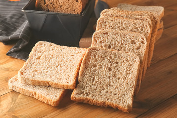 Sliced rye bread on wooden table closeup