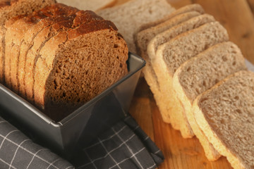 Sliced rye bread on wooden table closeup