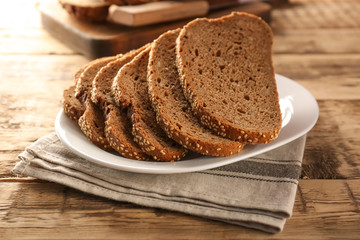 Sliced rye bread on wooden table closeup