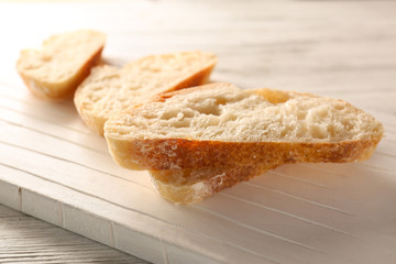 Sliced fresh bread on wooden background
