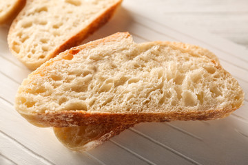 Sliced fresh bread on wooden cutting board closeup