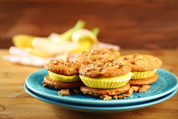 Plate with delicious lemon ice cream cookie sandwiches on wooden table