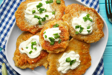 Plate with tasty potato pancakes for Hanukkah on wooden table, closeup