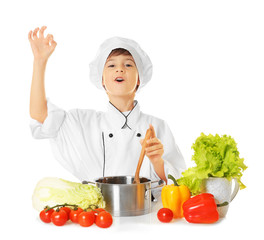 Cute boy in chef uniform preparing tasty soup, on white background