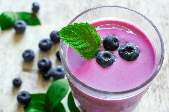 glass of fresh homemade berry smoothie with mint