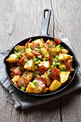 Fried potatoes with bacon and green onion