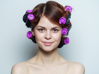 happy woman with curlers on head