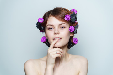 Naklejka premium happy woman with curlers on head