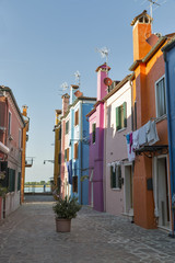 Fototapeta na wymiar Narrow Mediterranean style street on Burano island, Italy.