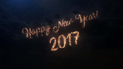 Fototapeta na wymiar 2017 Happy New Year greeting text with particles and sparks on black night sky with colored slow motion fireworks on background, beautiful typography magic design.
