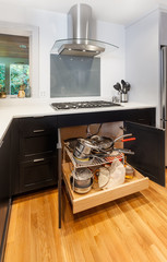 Pullout storage drawer for pots and pans underneath the cooktop