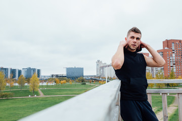 Sport fitness man posing against the backdrop of the city. Male athlete outside fall park. Fit   model.