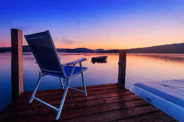 Chair at the end of the dock to watch sunrise over the lake