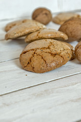 Macaroons cookies  and walnut on the white wooden background
