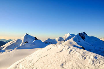 Stunning sunrise at 3800m amsl in the Swiss Wallis Alps near the summit of Alphubel (4206m)....