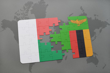puzzle with the national flag of madagascar and zambia on a world map