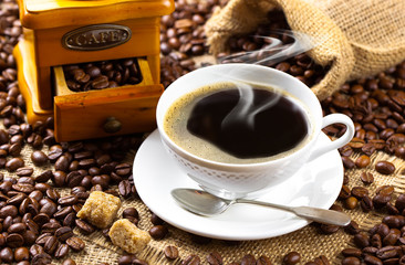 Black coffee in a cup on old background