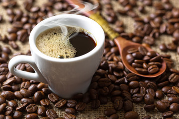 Black coffee in a cup on old background