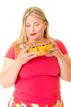 Overweight Woman With Bowl Of Chips And Chocolate.