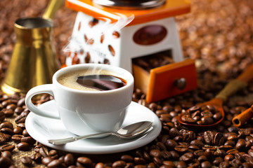 Black coffee in a cup on old background