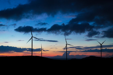 Obraz premium wind turbine sunset time, silhouette