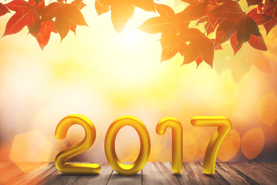 Gold 2017 Text on old wood on red maple in autumn and bokeh light background for Happy New Year Concept. - Powered by Adobe