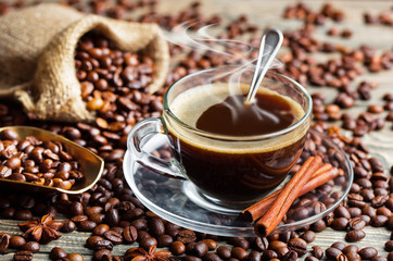 Black coffee in a cup on old background