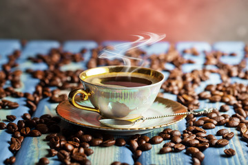 Black coffee in a cup on old background