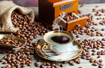 Black coffee in a cup on old background