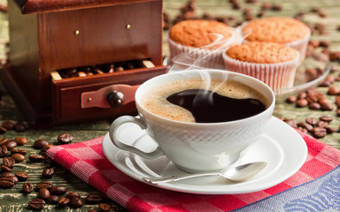 Black coffee in a cup on old background