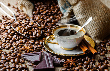 Black coffee in a cup on old background