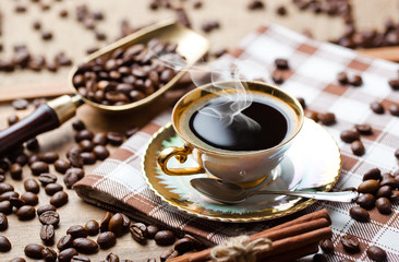 Black coffee in a cup on old background