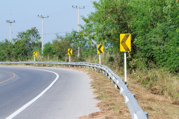 Yellow road signs warn Drivers for Ahead Dangerous Curve