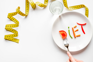 concept slimming diet fresh vegetables on white background top view