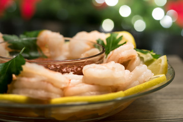 Shrimp cocktail and sauce with Christmas lights in background