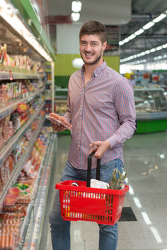 Young Man Shopping In The Supermarket