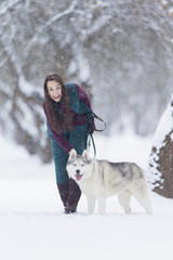 Happy Smiling Caucasian Brunette Woman and Her Husky Dog. Playing Outdoors
