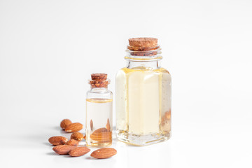 cosmetic almond oil in glass bottle on white background