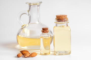 cosmetic almond oil in glass bottle on white background