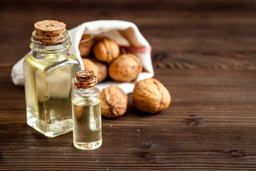 cosmetic and therapeutic walnut oil on dark wooden background