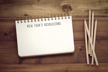 New year's resolutions on paper note book background