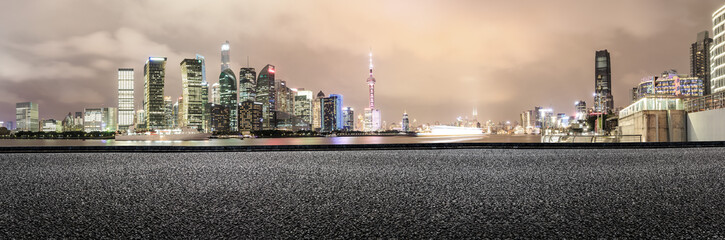 Asphalt road and modern cityscape panoramic view at night in Shanghai