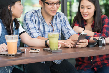 three people using smartphone in coffee shop, internet of things