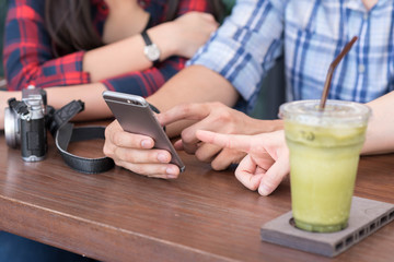 Fototapeta na wymiar three people using smartphone in coffee shop, internet of things