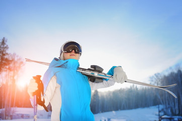 Woman Smiling And Holding Skiing. The Ski Resort.