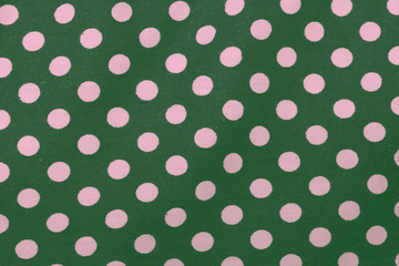 Seamless green and pink polka dot fabric background