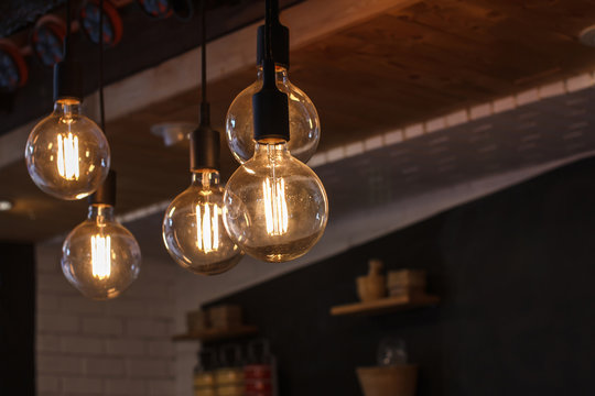 Decorative antique style filament LED light bulbs in restaurant.