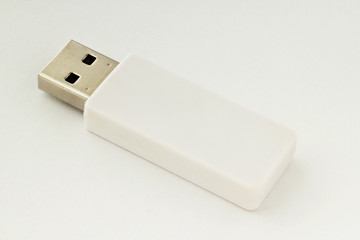 White USB flash drive on a white background. Full focus front and back.