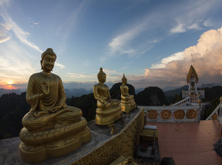 Statues of Buddha at Tiger Temple on the top of karst mount at K
