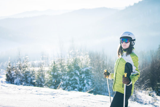 Young woman is skiing in mountains